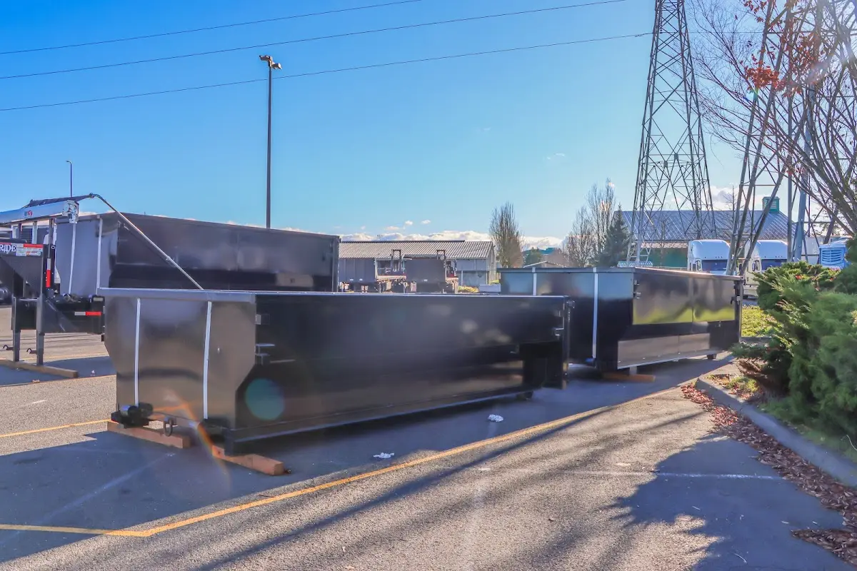 Roll-off dumpster ready for waste disposal at job site for Concrete Dumpster Rental in Atkinson